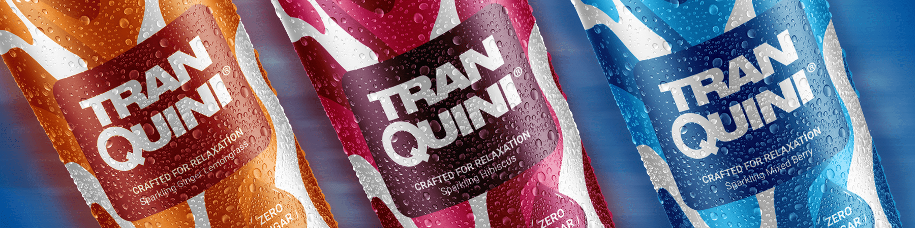 Image showing a Tranquini Variety Pack of beverage cans. The cans, from left to right, are orange, red, and blue with droplets of condensation suggesting they are cold. All cans have "Crafted for Relaxation Sparkling Tonic" written on the label.